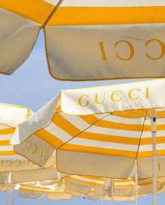 Yellow & white Gucci beach parasols 