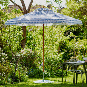 Blue & white parasol in a garden