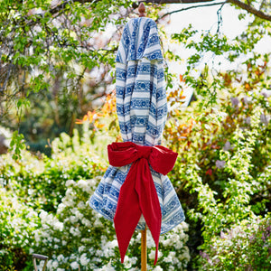 Blue and white parasol with red bow