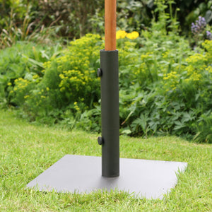 Black steel parasol base on grass