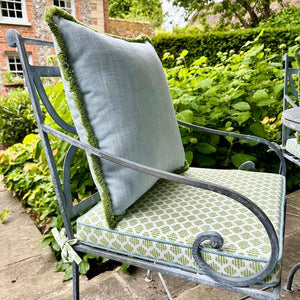 Metal garden chair with green and blue cushions