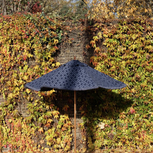 Navy blue parasol in autumn garden