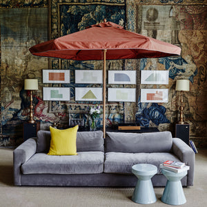 Red garden parasol in a living room