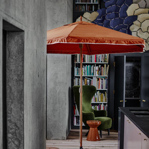 Orange parasol inside a house